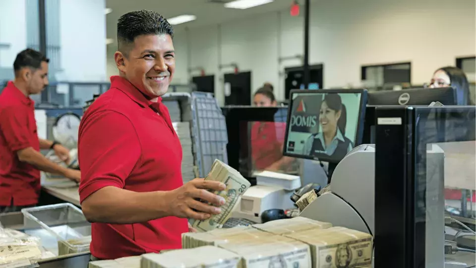 Loomis employee processing cash