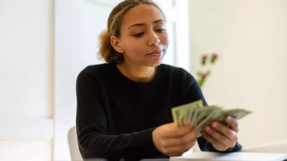 Woman Holding Cash