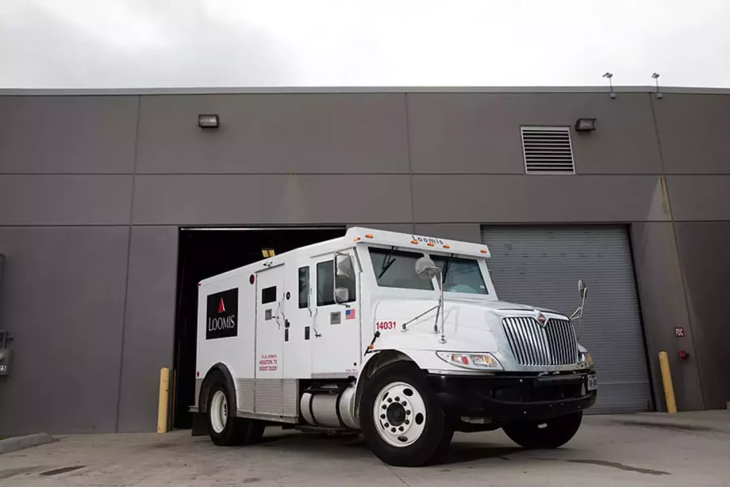 Loomis armored truck managing cash transportation